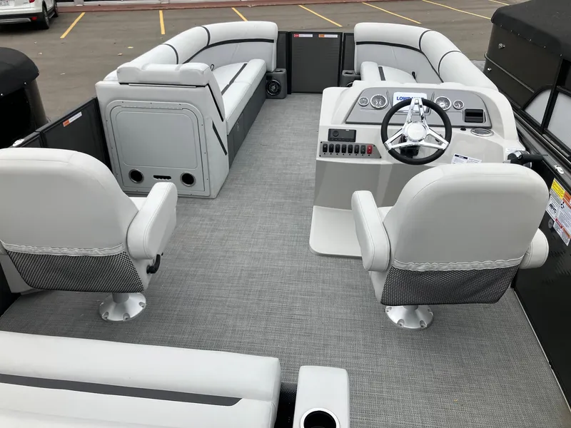 Slide: The Image of 2024 Crest 240 SLSC Classic LX pontoon boat interior with helm and seating. - 6