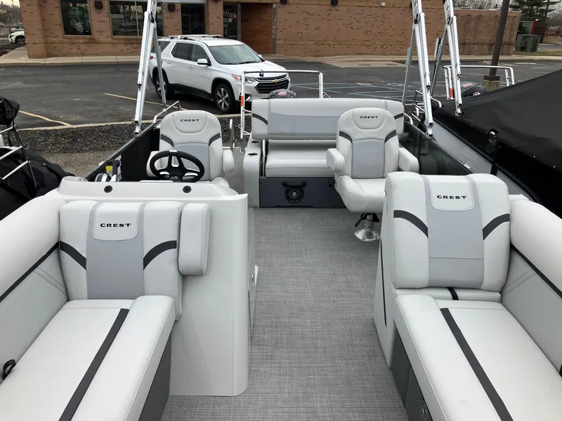 Slide: The Image of 2024 Crest 240 SLSC Classic LX pontoon boat with luxurious seating and modern design. - 9