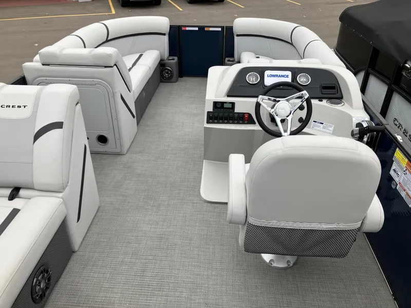 Slide: The Image of 2023 Crest 220 SLC Classic LX pontoon boat interior with plush seating and modern helm. - 6