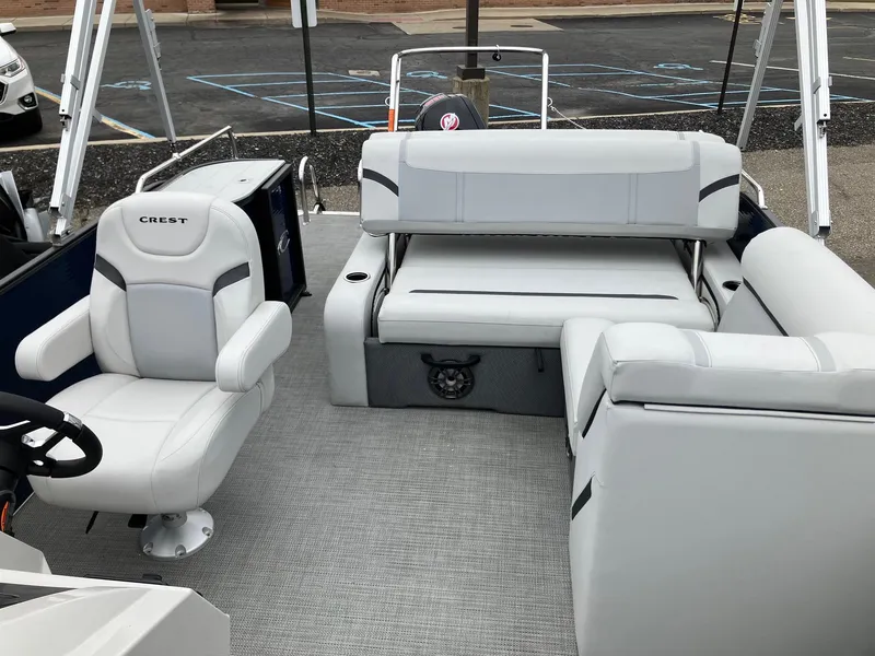 Slide: The Image of 2023 Crest 220 SLC Classic LX pontoon boat interior with plush seating and modern design. - 9