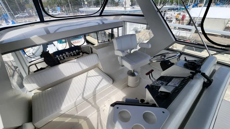 Slide: The Image of Interior of 1995 Carver 440 Aft Cabin Motor Yacht with helm and seating area. - 15