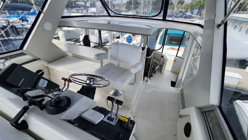 Slide: The Image of 1995 Carver 440 Aft Cabin Motor Yacht interior with helm and seating area. - 16
