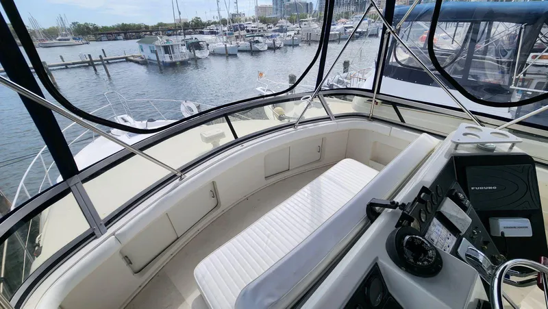 Slide: The Image of 1995 Carver 440 Aft Cabin Motor Yacht helm with marina view. - 17