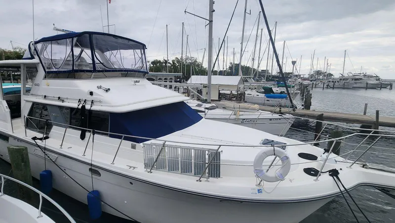 Slide: The Image of 1995 Carver 440 Aft Cabin Motor Yacht docked at marina. - 2