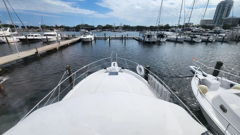 Slide: The Image of 1995 Carver 440 Aft Cabin Motor Yacht docked in a marina with other boats. - 24