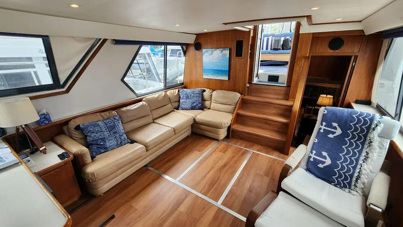 Slide: The Image of Luxurious interior of 1995 Carver 440 Aft Cabin Motor Yacht with leather seating and nautical decor. - 26