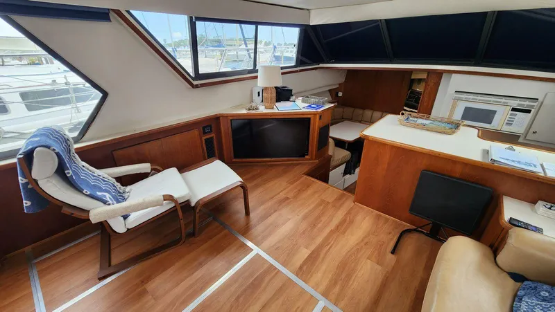 Slide: The Image of Interior of 1995 Carver 440 Aft Cabin Motor Yacht with modern furnishings and wood flooring. - 27