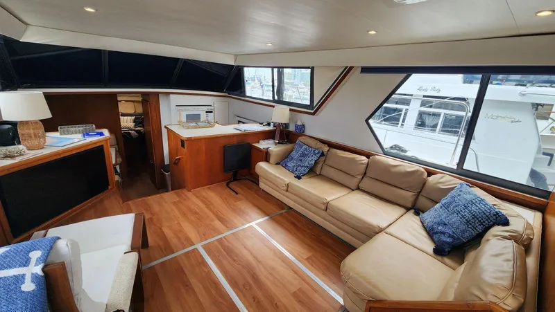 Slide: The Image of Luxurious interior of 1995 Carver 440 Aft Cabin Motor Yacht with leather seating and wood flooring. - 28