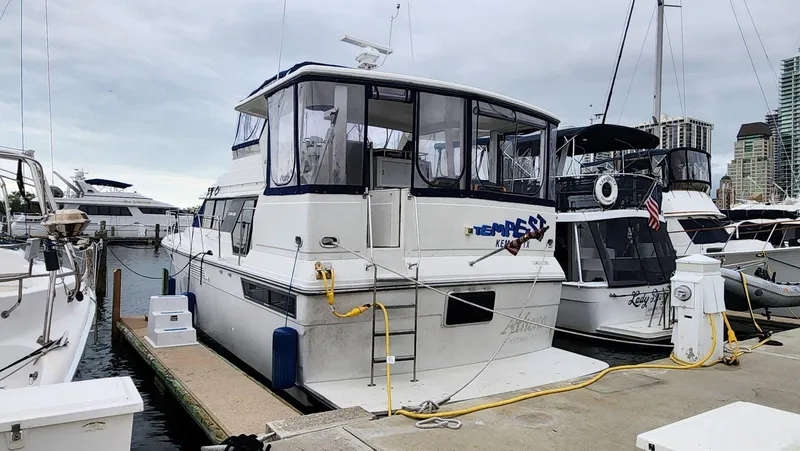 Slide: The Image of 1995 Carver 440 Aft Cabin Motor Yacht docked at marina. - 3