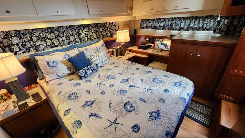 Slide: The Image of Cozy bedroom in 1995 Carver 440 Aft Cabin Motor Yacht with nautical-themed decor. - 37
