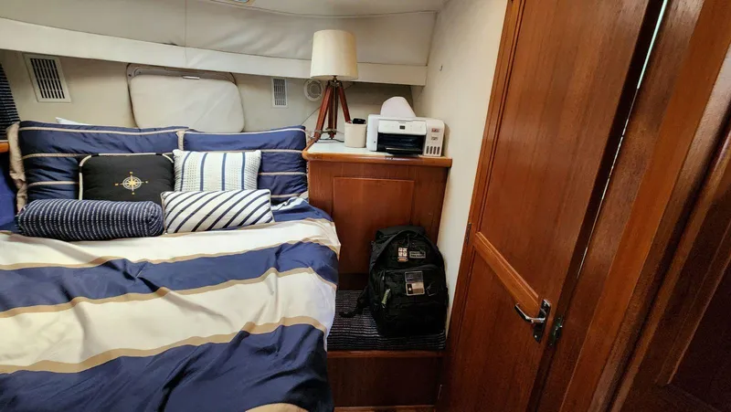 Slide: The Image of Cozy cabin interior of 1995 Carver 440 Aft Cabin Motor Yacht with nautical bedding. - 43