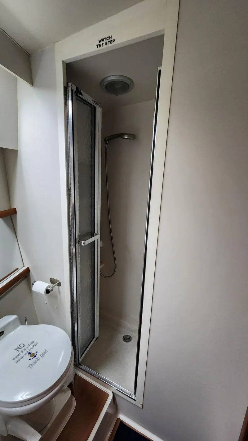 Slide: The Image of 1995 Carver 440 Aft Cabin Motor Yacht bathroom with shower and toilet. - 46