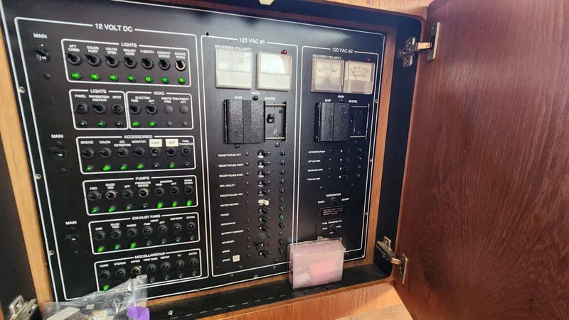 Slide: The Image of Electrical panel of a 1995 Carver 440 Aft Cabin Motor Yacht, showing switches and meters. - 47