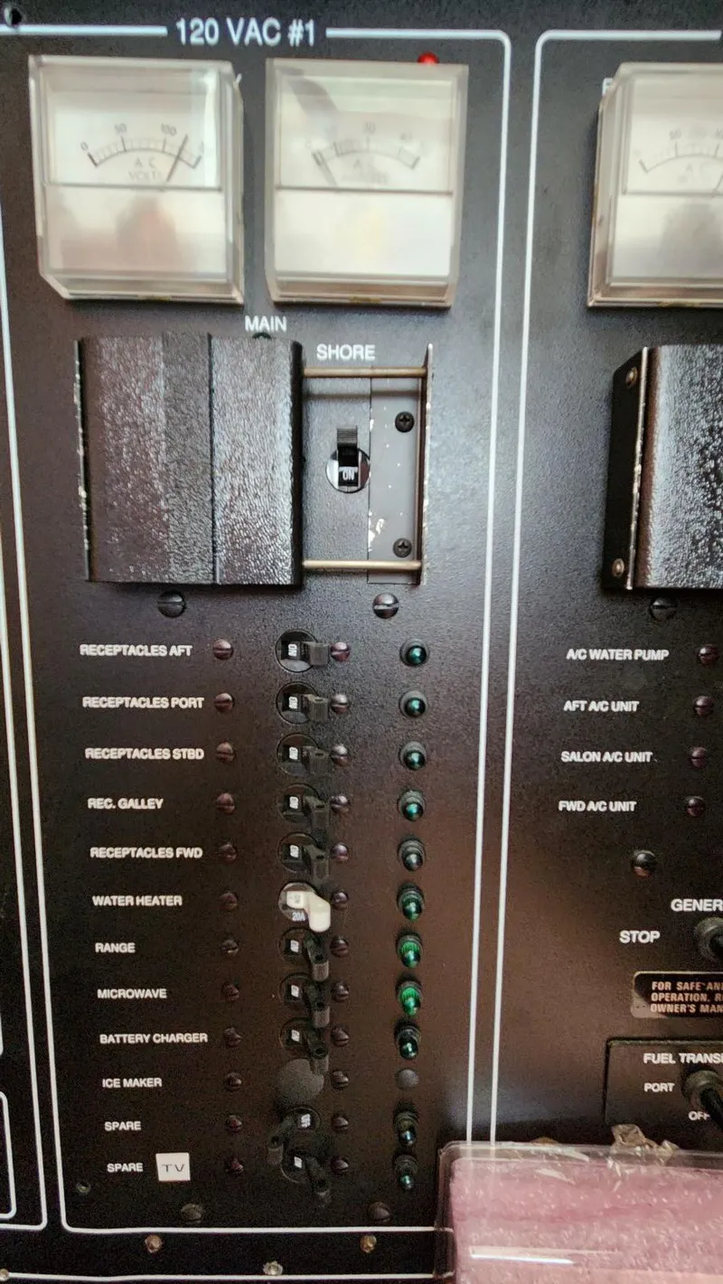 Slide: The Image of Control panel of a 1995 Carver 440 Aft Cabin Motor Yacht with switches and indicators. - 49