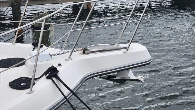 Slide: The Image of 1995 Carver 440 Aft Cabin Motor Yacht bow with anchor and railing on water. - 5