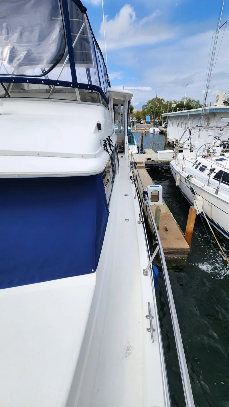 Slide: The Image of 1995 Carver 440 Aft Cabin Motor Yacht docked at marina, side view. - 6