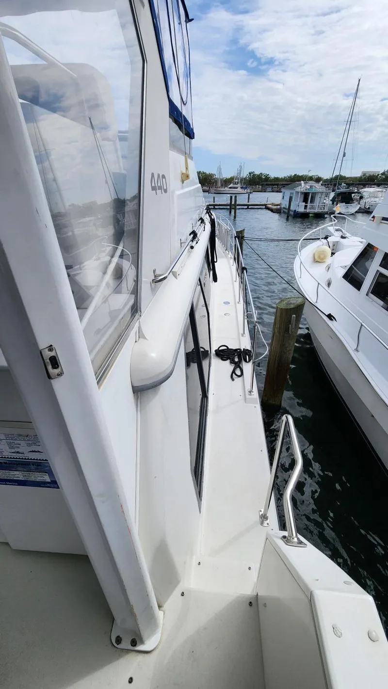 Slide: The Image of 1995 Carver 440 Aft Cabin Motor Yacht docked at marina, side view. - 9