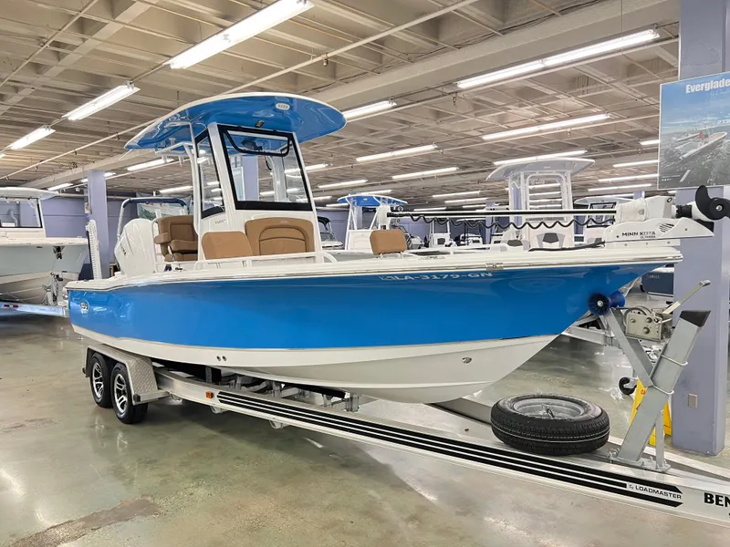 Slide: The Image of 2022 Sea Hunt BX25FS boat in showroom, blue hull, on trailer. - 3