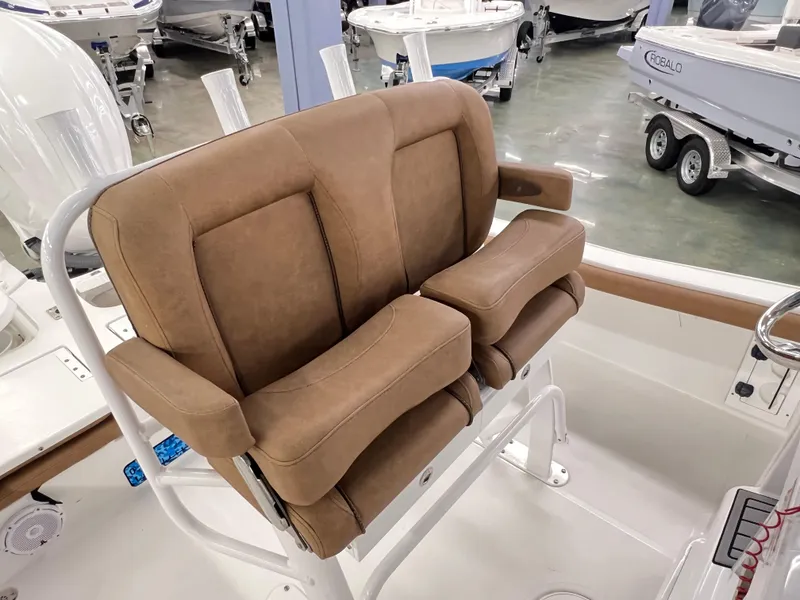Slide: The Image of 2022 Sea Hunt BX25FS boat seat with tan upholstery in showroom. - 4