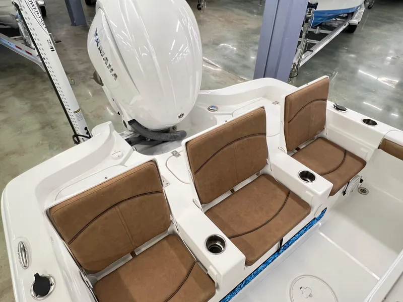 Slide: The Image of 2022 Sea Hunt BX25FS boat with Yamaha engine, featuring brown cushioned seats and cup holders. - 7