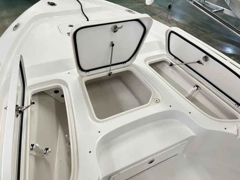 Slide: The Image of 2022 Sea Hunt BX25FS boat with open storage compartments on deck. - 9