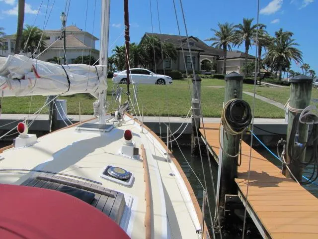 Slide: The Image of Sailboat docked near waterfront homes, Custom Lazy Jack 32, 1974 model. - 13