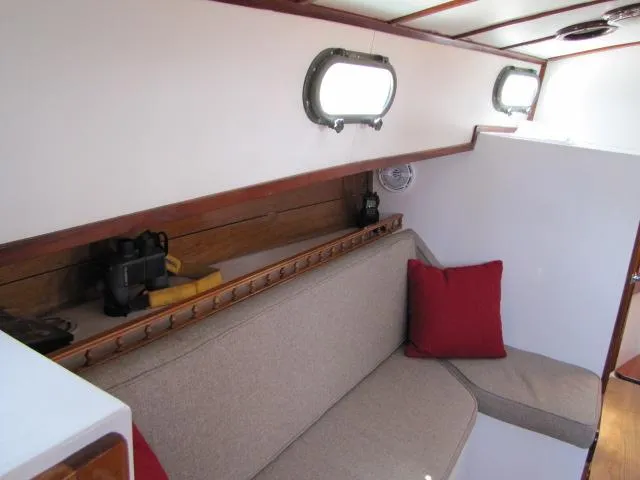 Slide: The Image of Interior of 1974 Custom Lazy Jack 32 sailboat with beige seating and red cushions. - 14