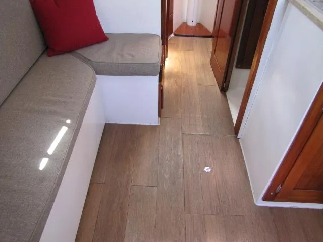 Slide: The Image of Interior of 1974 Custom Lazy Jack 32 with wooden flooring and cushioned seating. - 16