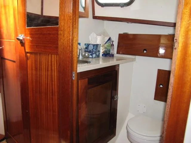 Slide: The Image of 1974 Custom Lazy Jack 32 yacht bathroom with wooden cabinetry and compact design. - 18