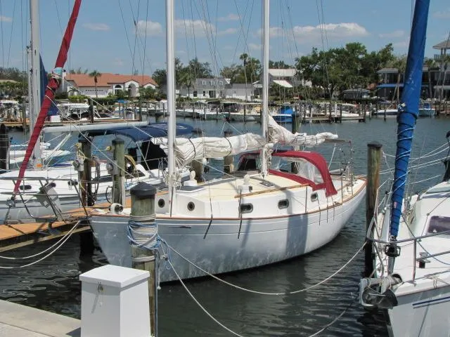 Slide: The Image of 1974 Custom Lazy Jack 32 sailboat docked in a marina, surrounded by other boats. - 4