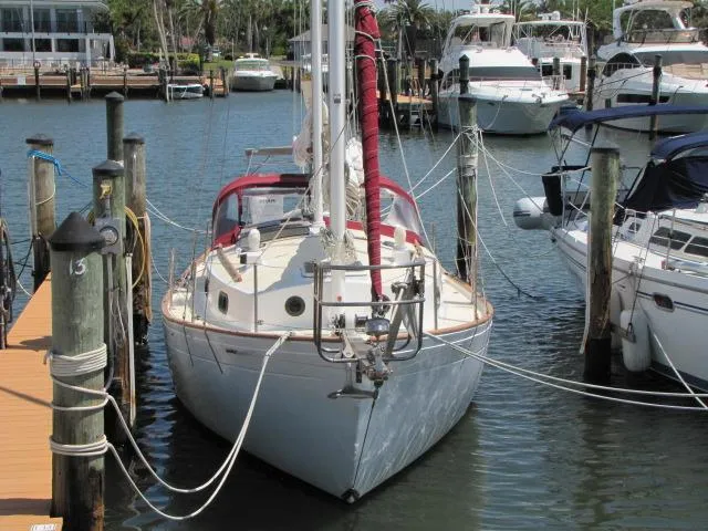 Slide: The Image of 1974 Custom Lazy Jack 32 sailboat docked in a marina, surrounded by other boats. - 5