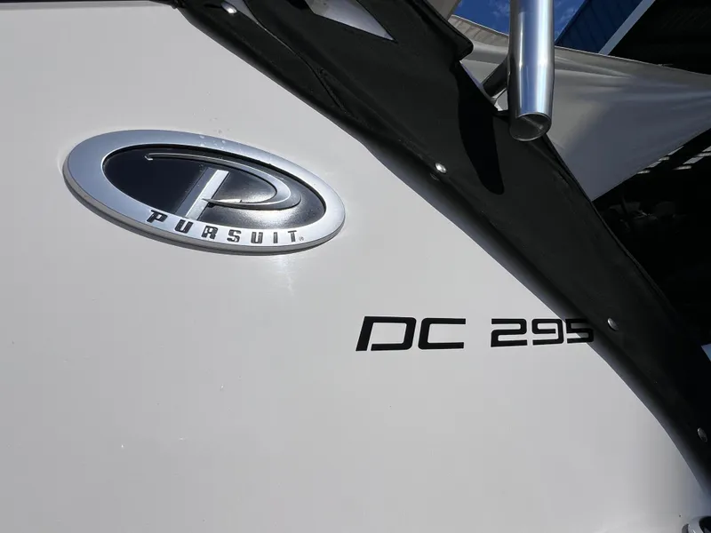 Slide: The Image of 2016 Pursuit DC 295 Dual Console boat with logo and model name visible. - 12