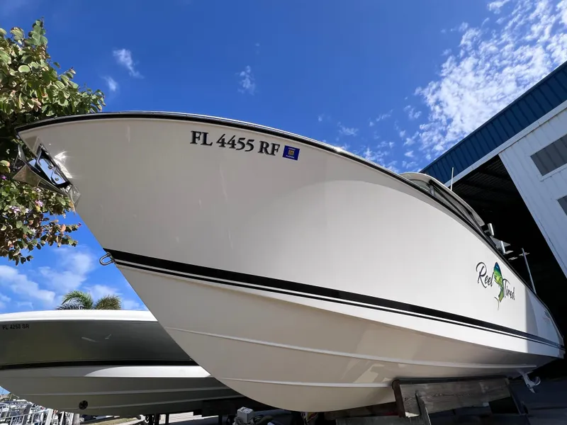 Slide: The Image of 2016 Pursuit DC 295 Dual Console boat with Twin Yamaha 300 engines, docked under clear sky. - 14