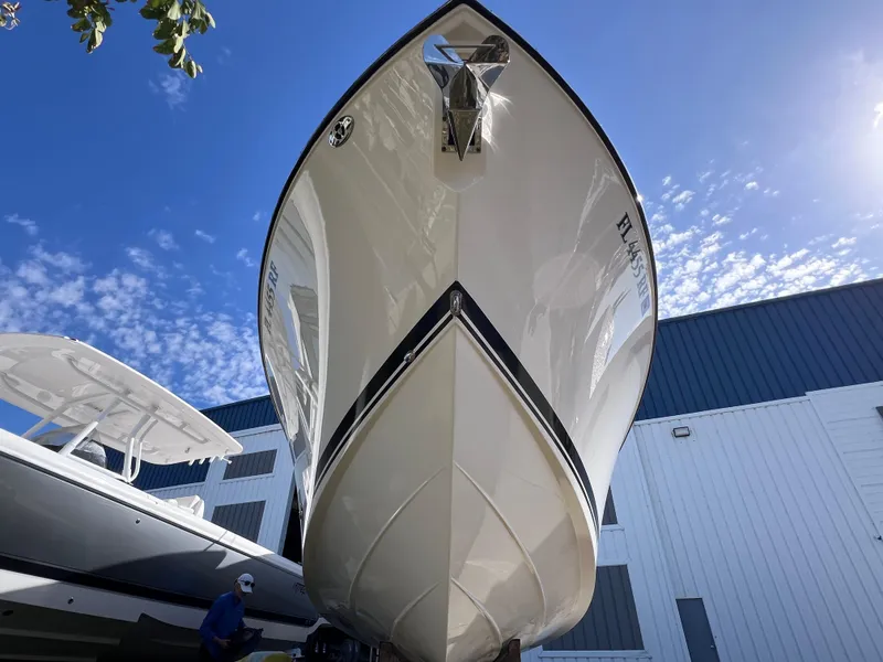 Slide: The Image of 2016 Pursuit DC 295 boat with twin Yamaha 300 engines, docked under clear blue sky. - 15