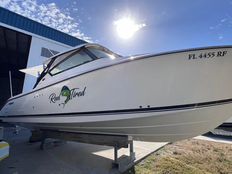 Slide: The Image of 2016 Pursuit DC 295 boat with twin Yamaha 300 engines, docked under sunny sky. - 17