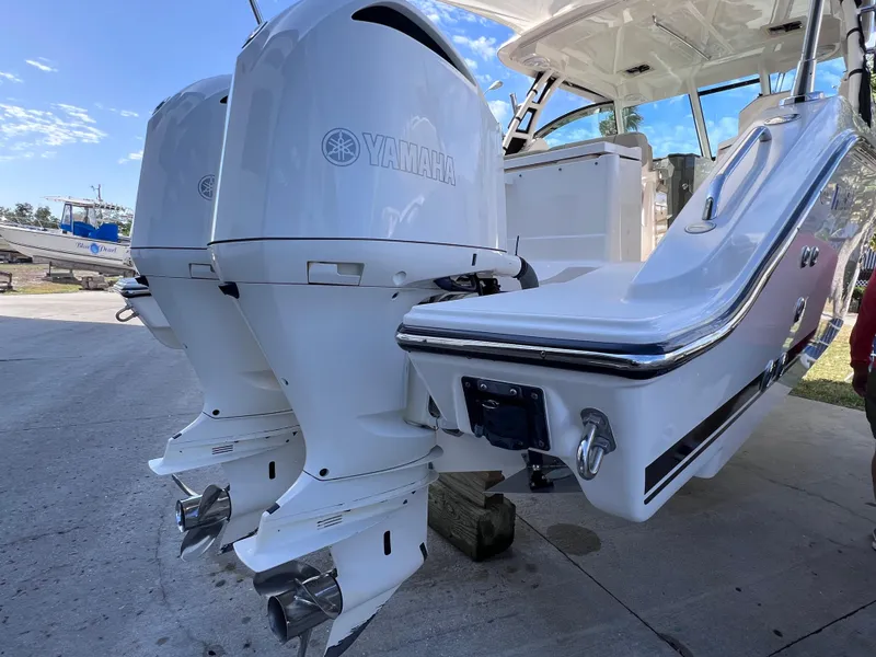 Slide: The Image of 2016 Pursuit DC 295 boat with twin Yamaha 300 engines, docked on a sunny day. - 20