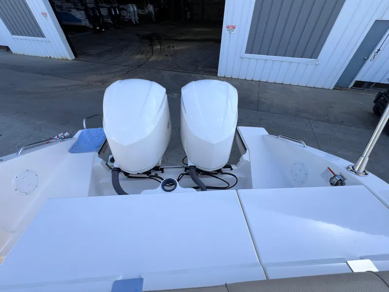 Slide: The Image of 2016 Pursuit DC 295 boat with twin Yamaha 300 engines, docked in a marina. - 24