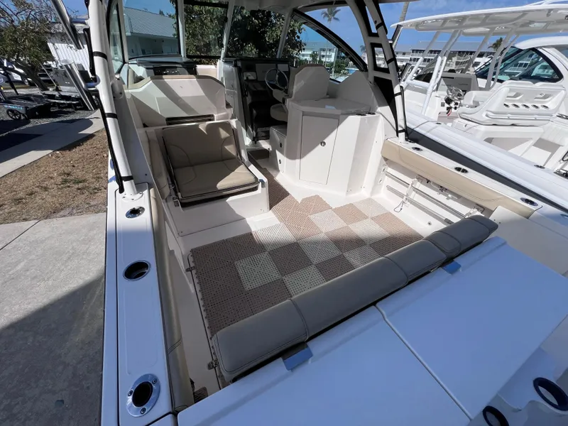 Slide: The Image of 2016 Pursuit DC 295 Dual Console boat interior with seating and helm, featuring twin Yamaha 300 engines. - 26