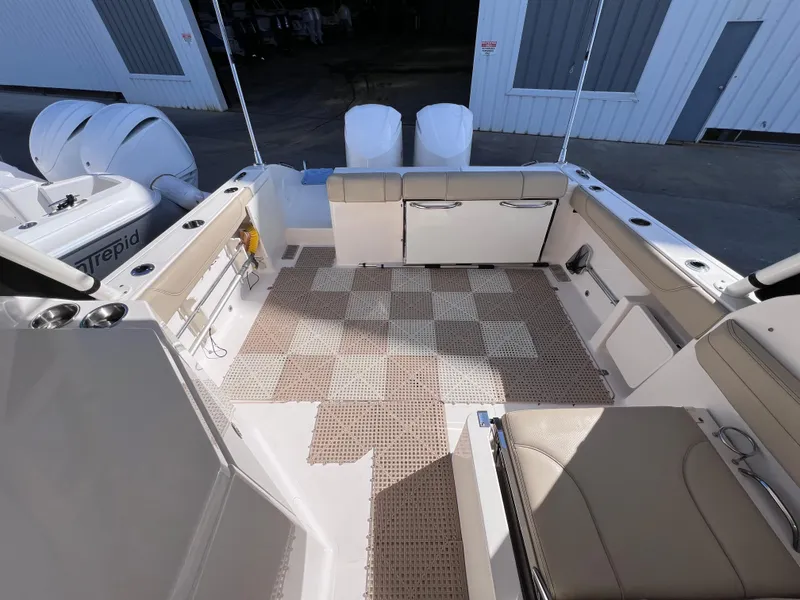 Slide: The Image of 2016 Pursuit DC 295 boat interior with twin Yamaha 300 engines, clean and spacious deck. - 28