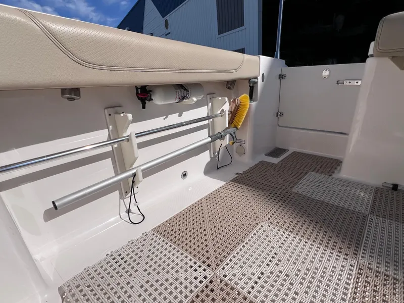 Slide: The Image of 2016 Pursuit DC 295 boat interior with clean deck and storage features. - 34