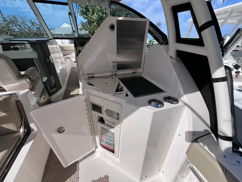 Slide: The Image of 2016 Pursuit DC 295 Dual Console interior with open storage and control panel. - 38