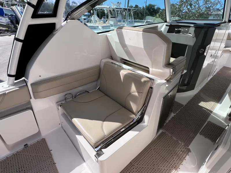 Slide: The Image of 2016 Pursuit DC 295 Dual Console interior with beige seating and modern design. - 40