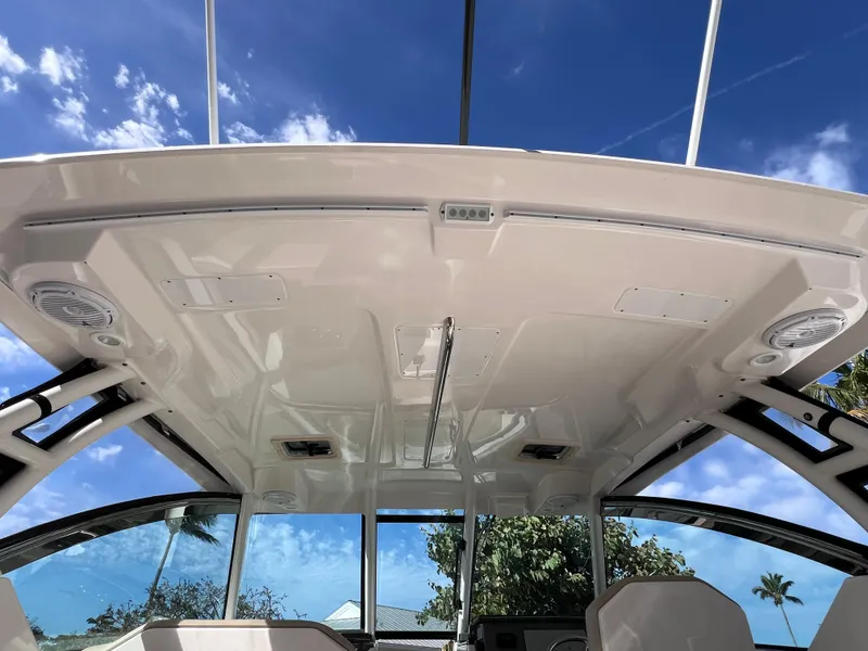 Slide: The Image of 2016 Pursuit DC 295 boat interior with sleek design and clear blue sky background. - 42