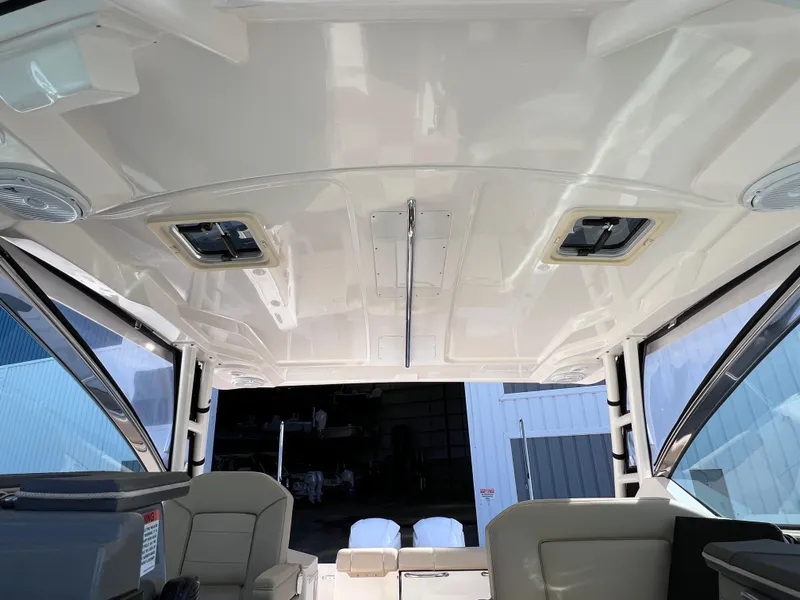 Slide: The Image of 2016 Pursuit DC 295 Dual Console interior with clean, spacious seating and modern design. - 43