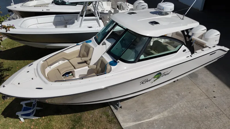 Slide: The Image of 2016 Pursuit DC 295 Dual Console boat with twin Yamaha 300 engines, docked outdoors. - 5