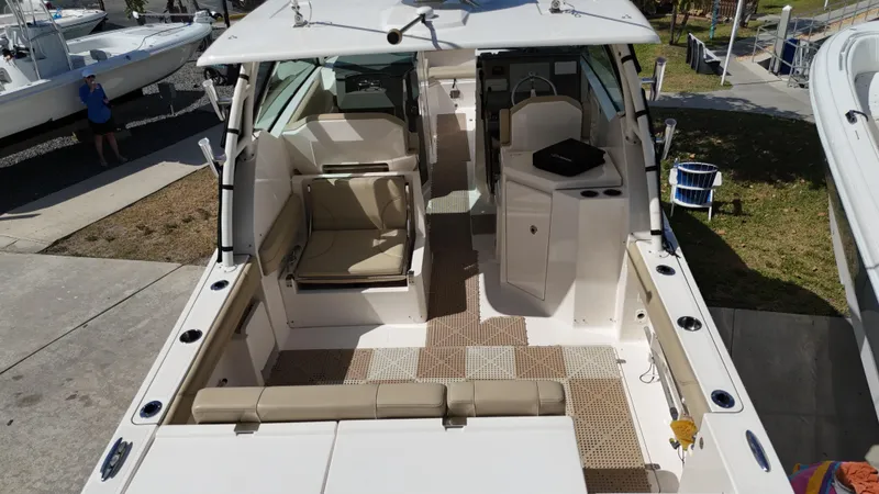 Slide: The Image of 2016 Pursuit DC 295 Dual Console boat with spacious seating and clean interior. - 7