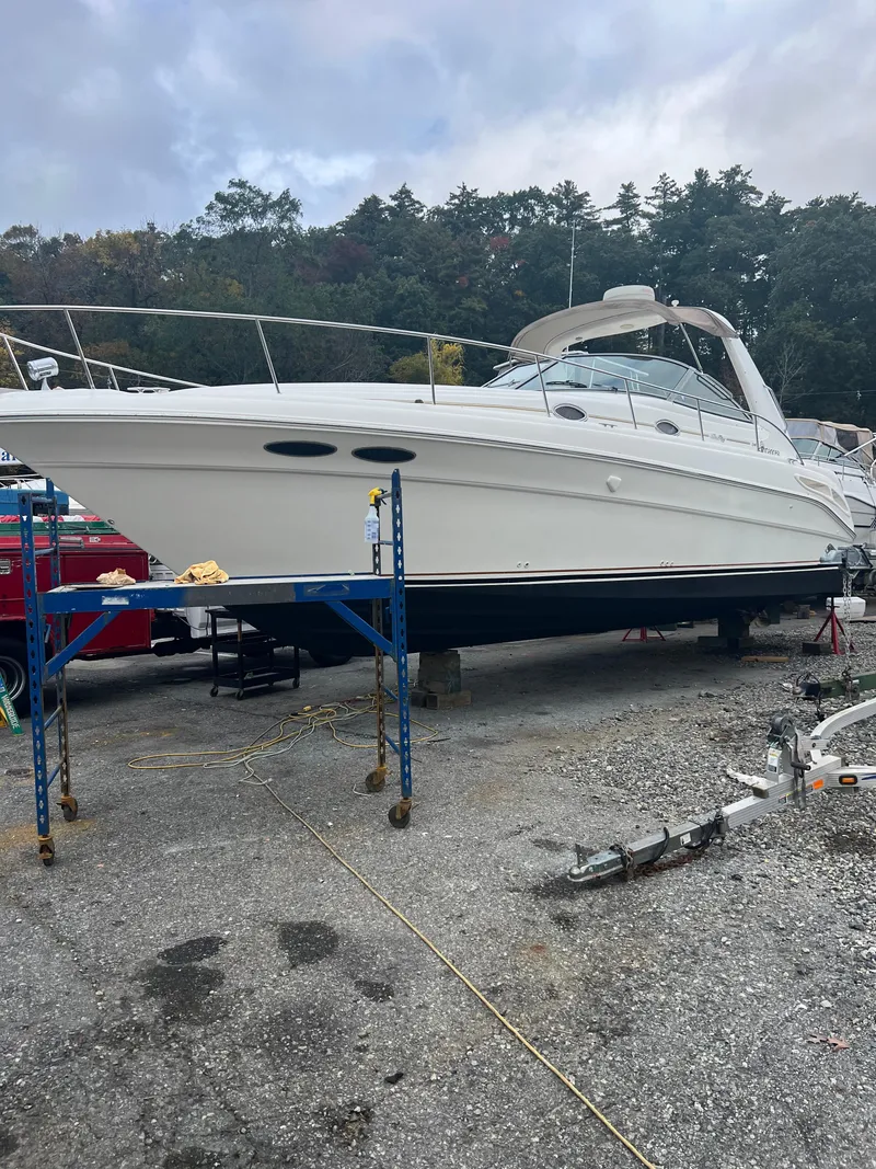Slide: The Image of 1999 Sea Ray 340 Sundancer boat on stands, ready for maintenance. - 4