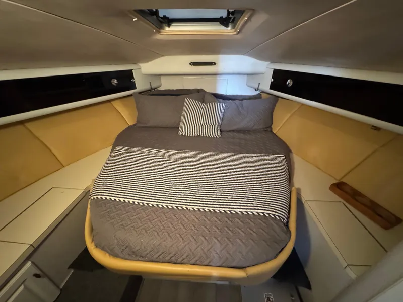 Slide: The Image of 1987 Silverton Express cabin interior with cozy bed and modern design. - 10