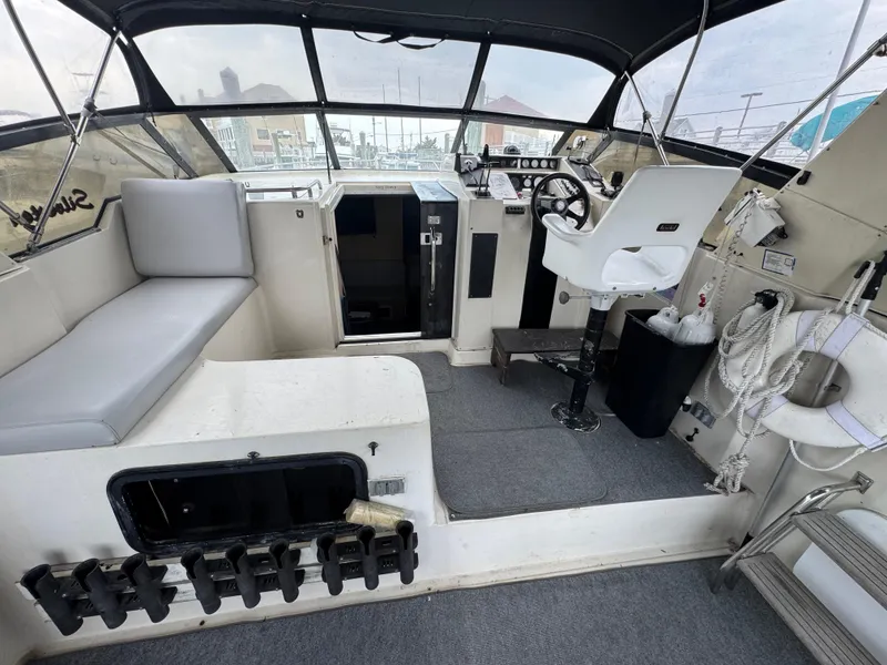 Slide: The Image of 1987 Silverton Express boat interior with helm, seating, and nautical equipment. - 3