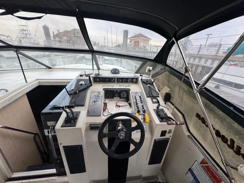 Slide: The Image of 1987 Silverton Express boat cockpit with steering wheel and control panel. - 4